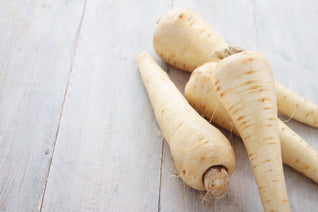 parsnips lying on a white surface